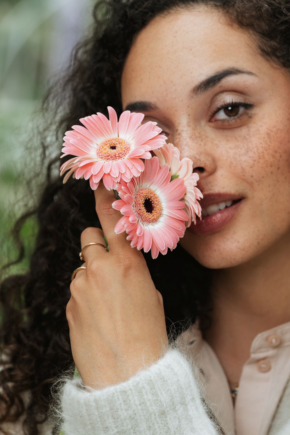 Mujer sosteniendo margaritas gerberas
